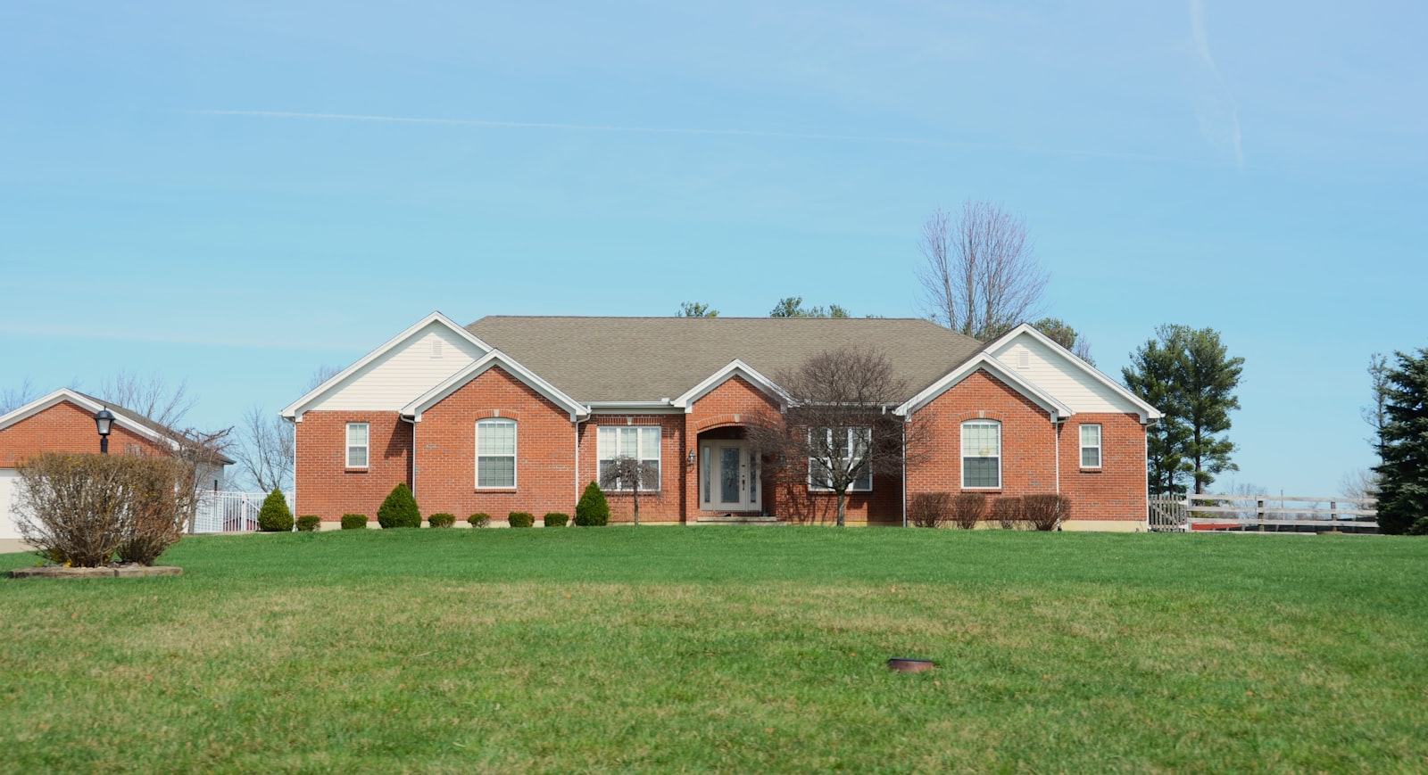 Brick home with a freshly cut, edged front lawn and clean walks.