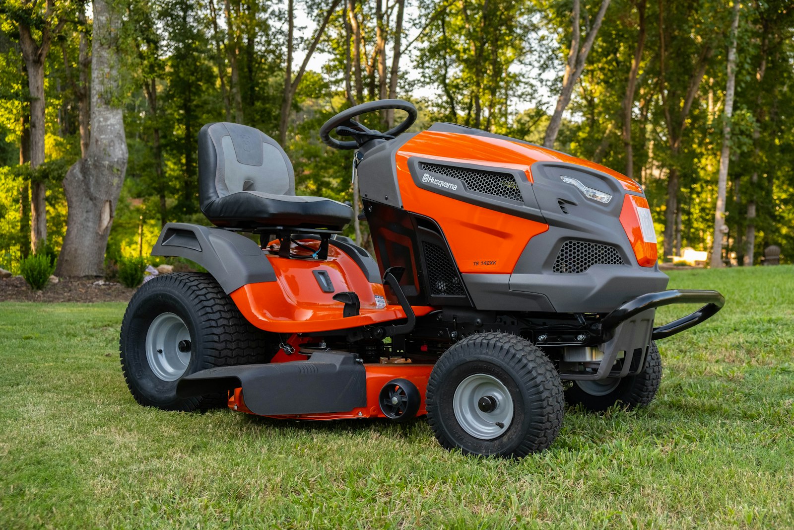 Zero-turn mower mid-pass across a wide residential lawn.